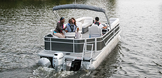 Four friends in a boat on the water 