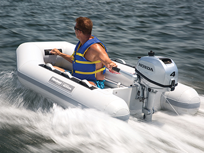 A man in a moving boat wearing a life jacket 